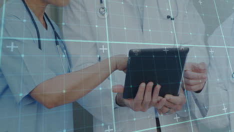 Medical-professionals-using-tablet,-grid-and-data-points-animation-over-them