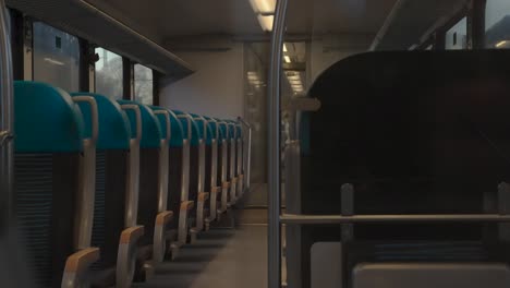 Dim-train-seats-in-Dutch-arrival,-evening-descent