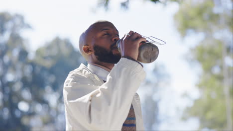 Hiking,-nature-and-black-man-drinking-water