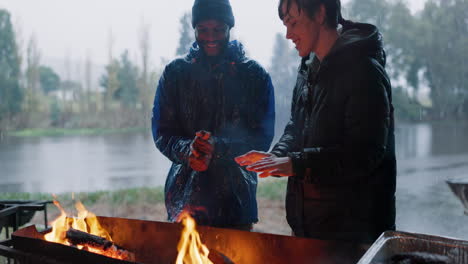 Fire,-warm-hands-and-friends-on-camping-adventure