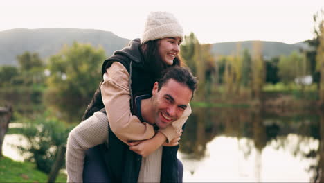 Couple-piggyback,-happy-and-in-nature-for-holiday