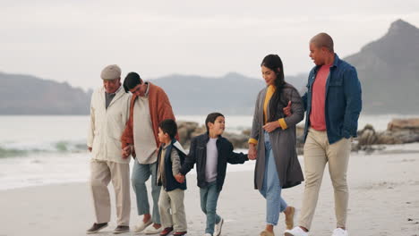 Family,-walking-on-beach-and-holding-hands