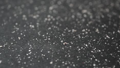 Dandruff-and-hairs-on-black-background-,