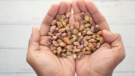 Close-up-of-pistachios-nut-on-hand