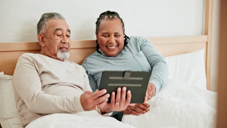 Happy,-tablet-and-mature-couple-in-bedroom