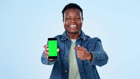 Man,-pointing-to-phone-green-screen