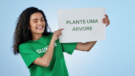 Volunteer,-sign-and-woman-plant-trees-in-studio