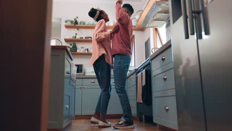 Happy-man,-woman-and-dancing-in-kitchen-for-fun