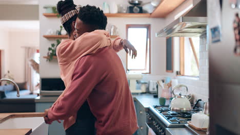 Dance,-hug-and-couple-in-kitchen-laughing-together