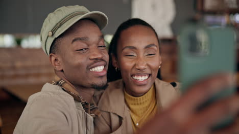 Selfie,-kiss-and-happy-black-couple-in-cafe