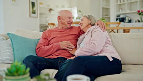 Senior-couple,-hug-and-talk-on-sofa-in-home-living