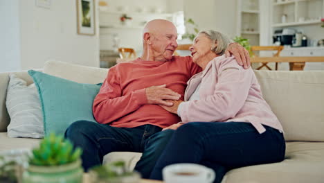 Hug,-kiss-and-senior-couple-on-a-sofa-relax
