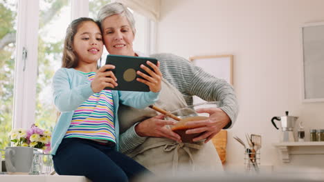 Tablet-selfie,-cooking-and-child-with-grandmother