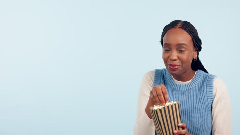 Black-woman-in-studio,-eating-popcorn