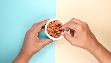 Top-view-of-hand-pick-almond-nuts