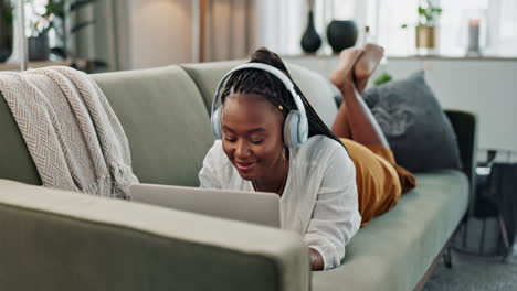 Home,-headphones-and-black-woman-on-a-couch