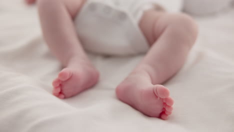 Sleeping,-adorable-and-feet-of-baby-on-bed