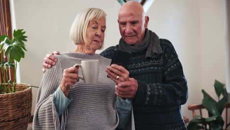 Home,-coffee-and-senior-couple-with-smartphone