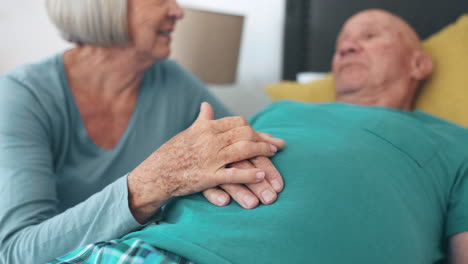 Holding-hands,-senior-couple-and-bed-with-empathy