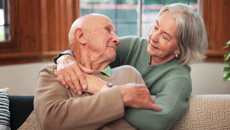 Senior,-couple-and-happy-hug-with-kiss-on-sofa