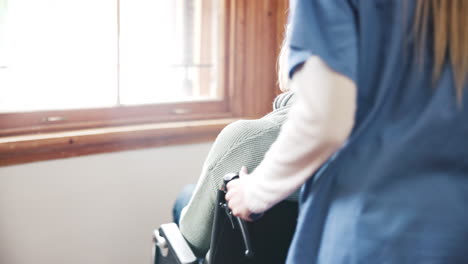 Wheelchair,-caregiver-and-senior-woman-in-nursing