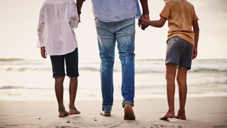 Holding-hands,-legs-of-family-on-beach-together