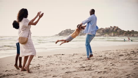 Playing,-happy-family-on-beach-together