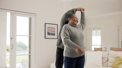 Senior-African-couple,-dancing-and-smile-in-home