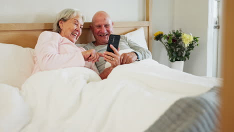 Phone,-relax-and-senior-couple-in-a-bed