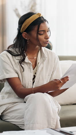 Woman,-calculator-and-budget-on-sofa-of-home