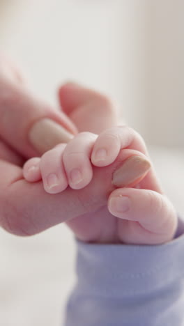 Closeup,-holding-hands-and-mother-with-baby