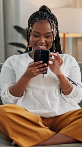 Woman,-laughing-or-scroll-on-smartphone-on-sofa