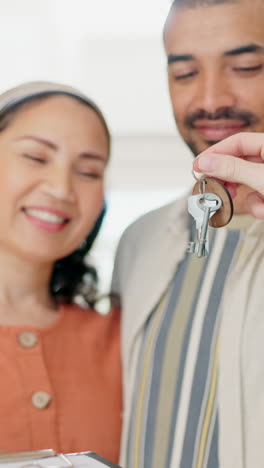Realtor,-giving-keys-and-couple-in-new-house