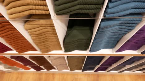 Close-up-of-ful-shirts-on-shelf-in-a-shop-,