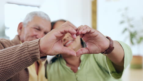Senior-couple,-heart-and-hands-for-love-in-home
