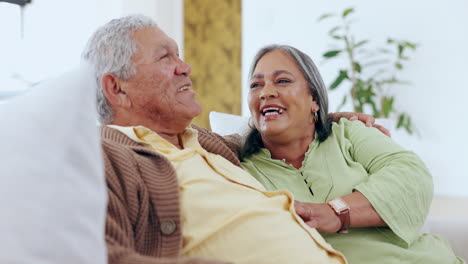 Love,-smile-and-a-senior-couple-laughing-on-a-sofa