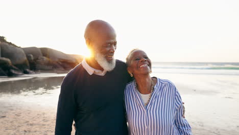 Senior,-couple-and-embrace-for-walking-on-beach