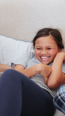 Happy,-tickling-and-parents-with-girl-on-bed