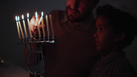 Jewish,-religion-and-a-family-lighting-candles