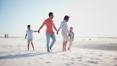 Family,-parents-and-kids-on-beach-with-holding