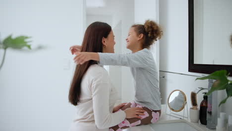 Mother,-daughter-and-hug-in-bedroom-for-love