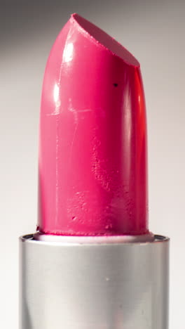 lipstick-turning-against-a-plain-white-background-in-vertical-format