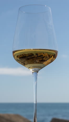 A-glass-with-white-wine-and-sparkling-sea