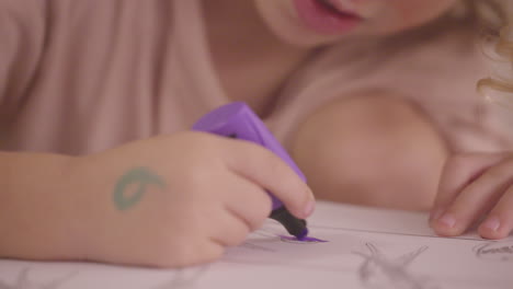 young-child-using-coloured-pen