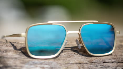 Mirrored-sunglasses-on-a-beach