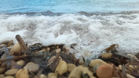 Slow-motion-footage-of-sea-splashing-on-stones-and-pebbles