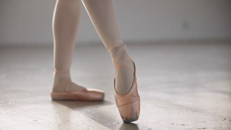 Ballerina,-pointe-shoes-and-stretching-feet