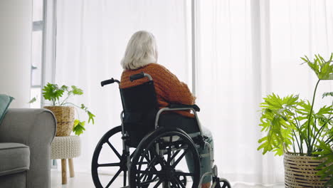Senior-woman,-wheelchair-and-window-for-thinking