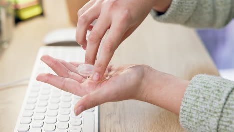 Closeup,-hands-and-medicine-while-typing-at-a-desk