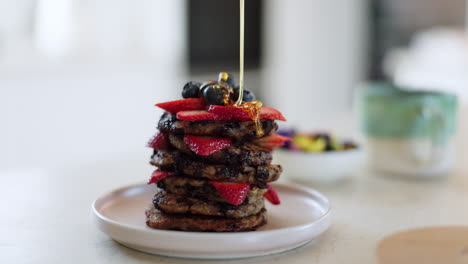 Pancake-stack,-honey-and-fruit-with-breakfast